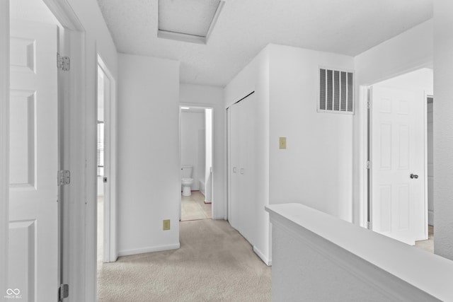 12443 Rose Haven Dr, Indianapolis, IN 46235 - corridor with light colored carpet and attic access