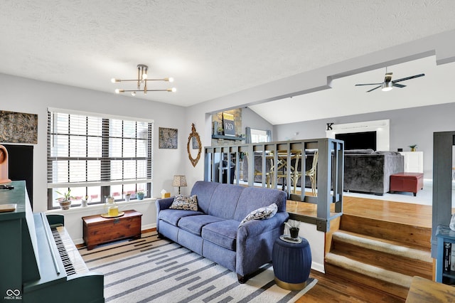 826 Royal Saint George Dr, Greenwood, IN 46143 - living room featuring wood finished floors, a chandelier, a textured ceiling, ceiling fan, and lofted ceiling