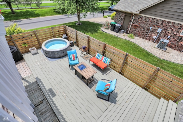 826 Royal Saint George Dr, Greenwood, IN 46143 - wooden deck with a hot tub, a fenced backyard, and an outdoor living space with a fire pit