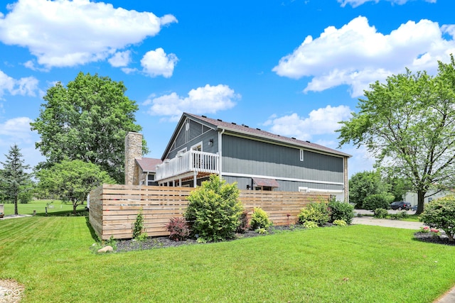 826 Royal Saint George Dr, Greenwood, IN 46143 - rear view of property with a chimney and a deck