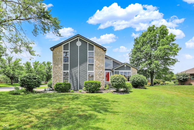 826 Royal Saint George Dr, Greenwood, IN 46143 - rear view of property featuring stone siding and a lawn