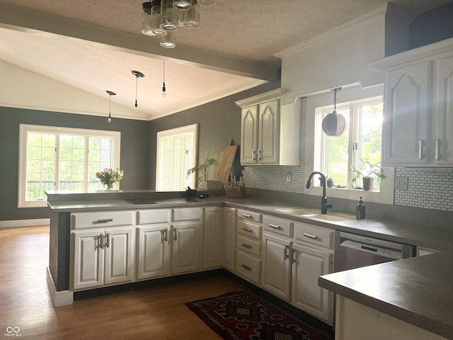 2131 Union St, Lafayette, IN 47904 - kitchen with a peninsula, dark wood-type flooring, decorative backsplash, pendant lighting, and crown molding