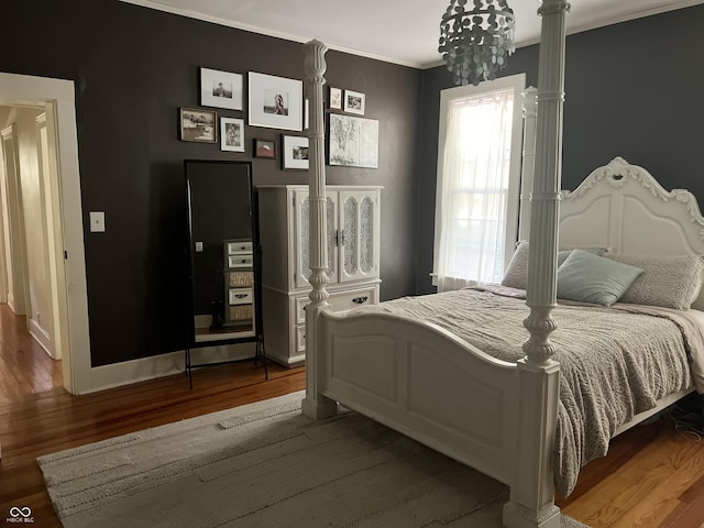 2131 Union St, Lafayette, IN 47904 - bedroom with wood finished floors, a chandelier, and crown molding