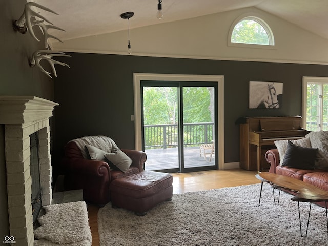 2131 Union St, Lafayette, IN 47904 - living area featuring lofted ceiling, light wood-style floors, and a brick fireplace