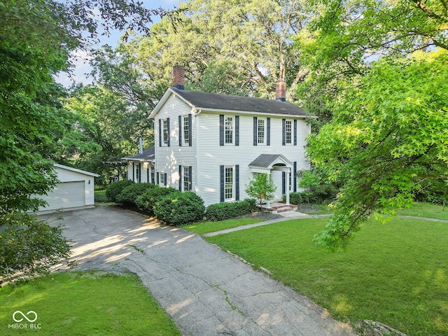 2131 Union St, Lafayette, IN 47904 - colonial home featuring a chimney, an outdoor structure, a front yard, and a garage