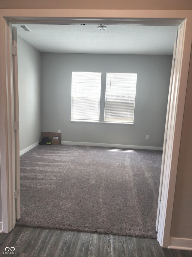 2431 S Carlota Dr, New Palestine, IN 46163 - spare room featuring dark carpet and baseboards