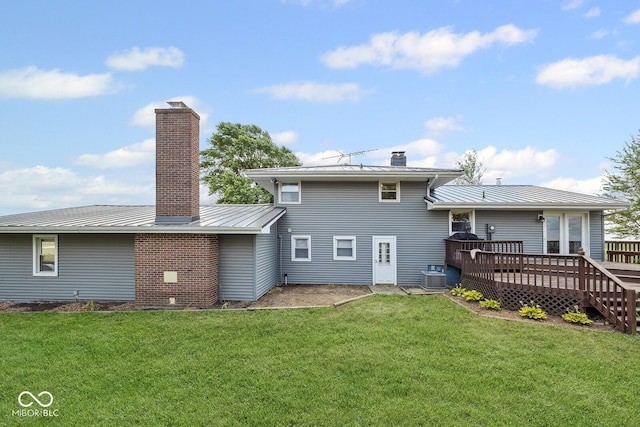 10227 E 500 S, Otterbein, IN 47970 - rear view of property featuring a chimney, a deck, a yard, and a metal roof