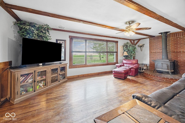 10227 E 500 S, Otterbein, IN 47970 - living area with a wood stove, wood finished floors, beam ceiling, and a ceiling fan