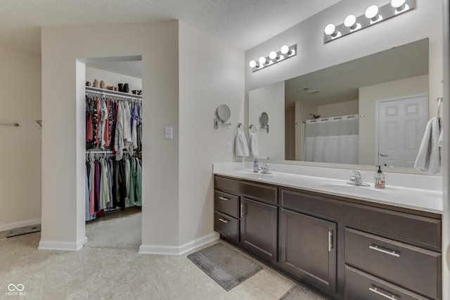 12291 Falling Leaves Trl, Indianapolis, IN 46229 - bathroom with double vanity, a spacious closet, and tile patterned flooring
