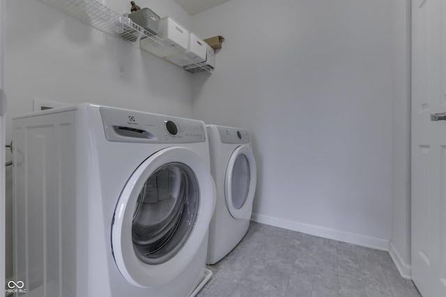 12291 Falling Leaves Trl, Indianapolis, IN 46229 - washroom with washer and clothes dryer and baseboards