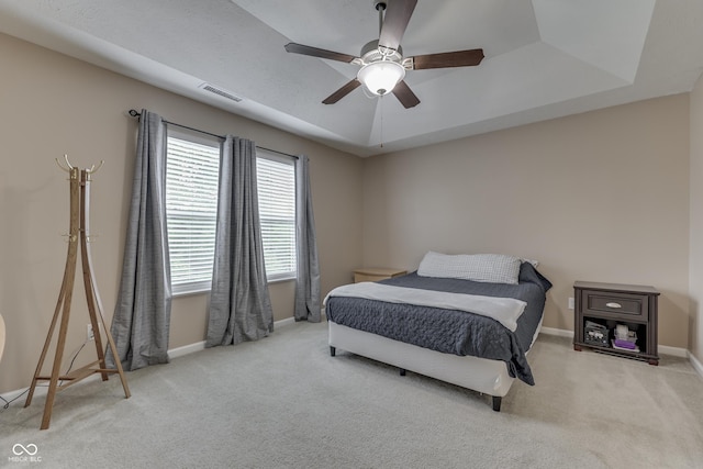 12291 Falling Leaves Trl, Indianapolis, IN 46229 - bedroom with carpet, a raised ceiling, and a ceiling fan
