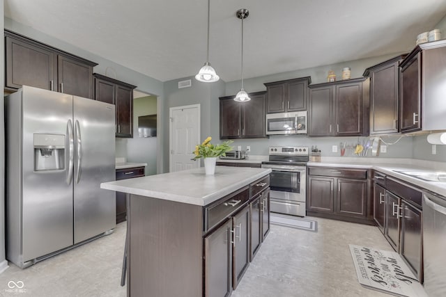 12291 Falling Leaves Trl, Indianapolis, IN 46229 - kitchen with stainless steel appliances, dark brown cabinets, light floors, and a center island