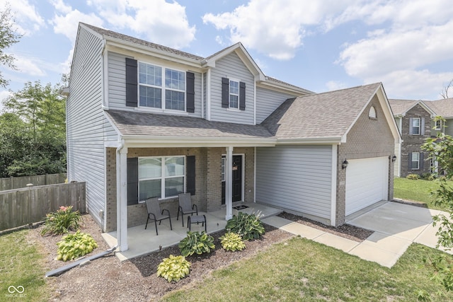 12291 Falling Leaves Trl, Indianapolis, IN 46229 - traditional home featuring covered porch, a garage, driveway, and brick siding