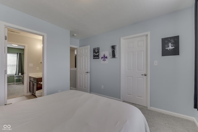 12291 Falling Leaves Trl, Indianapolis, IN 46229 - bedroom featuring light colored carpet and ensuite bathroom