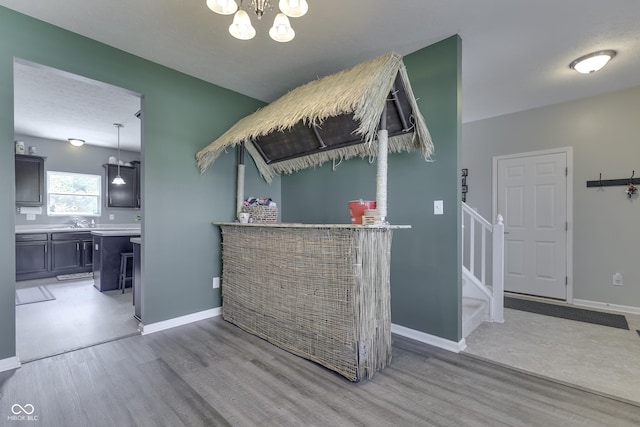 12291 Falling Leaves Trl, Indianapolis, IN 46229 - interior space with wood finished floors, a chandelier, stairs, and a dry bar