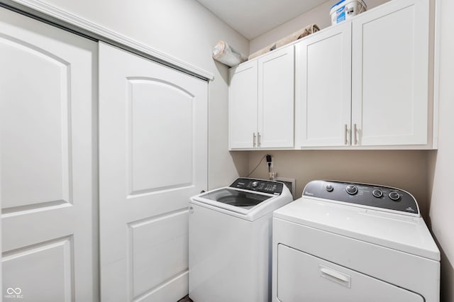 2584 Lanai Ln, Greenwood, IN 46143 - laundry area with cabinet space and washing machine and clothes dryer