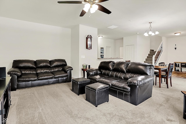 12075 Scoria Dr Unit 500, Fishers, IN 46038 - carpeted living area with stairway, ceiling fan, and a chandelier