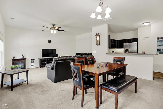 12075 Scoria Dr Unit 500, Fishers, IN 46038 - dining space featuring light colored carpet, a chandelier, and a ceiling fan