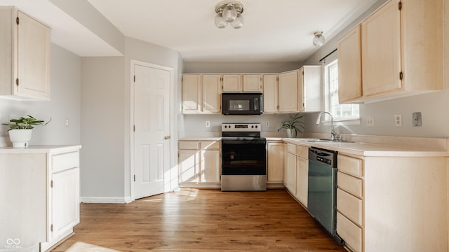 3923 N Bressingham Dr, Indianapolis, IN 46235 - kitchen featuring black microwave, electric range, dishwasher, light wood-type flooring, and light countertops