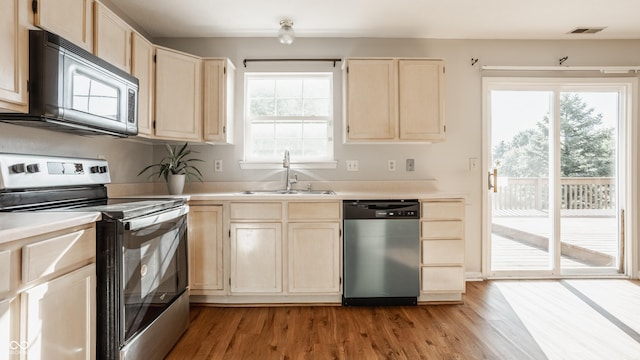 3923 N Bressingham Dr, Indianapolis, IN 46235 - kitchen featuring appliances with stainless steel finishes, light brown cabinets, light wood-type flooring, and light countertops