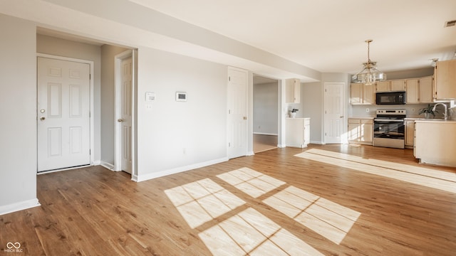3923 N Bressingham Dr, Indianapolis, IN 46235 - unfurnished living room featuring light wood finished floors and a chandelier