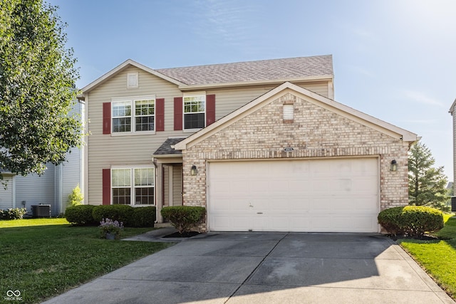 3923 N Bressingham Dr, Indianapolis, IN 46235 - traditional-style home featuring concrete driveway, a front lawn, an attached garage, brick siding, and roof with shingles