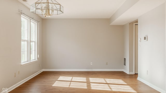 3923 N Bressingham Dr, Indianapolis, IN 46235 - empty room featuring a chandelier and light wood-style flooring
