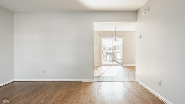 3923 N Bressingham Dr, Indianapolis, IN 46235 - spare room with a chandelier and wood finished floors