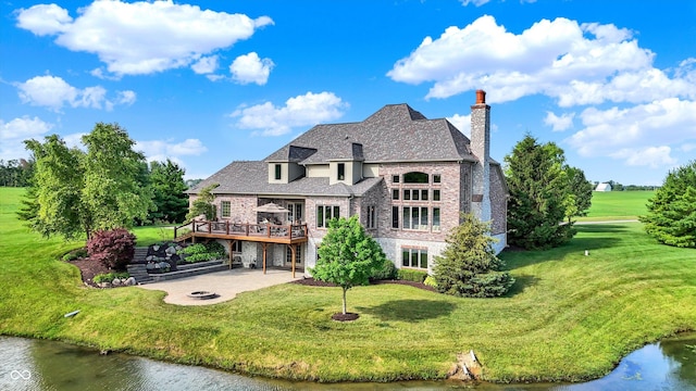 523 S 700 E, Whitestown, IN 46075 - back of property with a patio, a deck with water view, a chimney, a yard, and brick siding