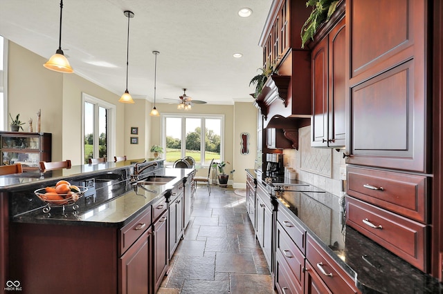 523 S 700 E, Whitestown, IN 46075 - kitchen with reddish brown cabinets, stone tile floors, ceiling fan, crown molding, and black electric cooktop