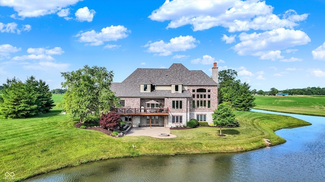 523 S 700 E, Whitestown, IN 46075 - back of house with a patio, a chimney, a deck with water view, a lawn, and brick siding