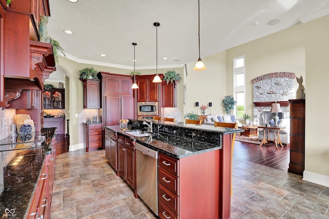 523 S 700 E, Whitestown, IN 46075 - kitchen with stainless steel appliances, dark brown cabinets, arched walkways, light stone finish flooring, and recessed lighting