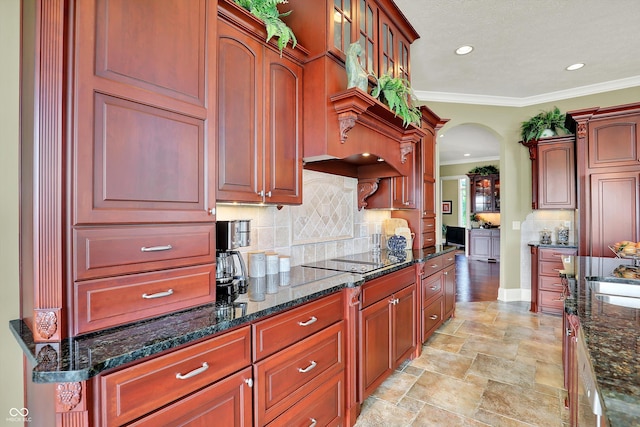 523 S 700 E, Whitestown, IN 46075 - kitchen with arched walkways, crown molding, black electric cooktop, tasteful backsplash, and dark stone counters