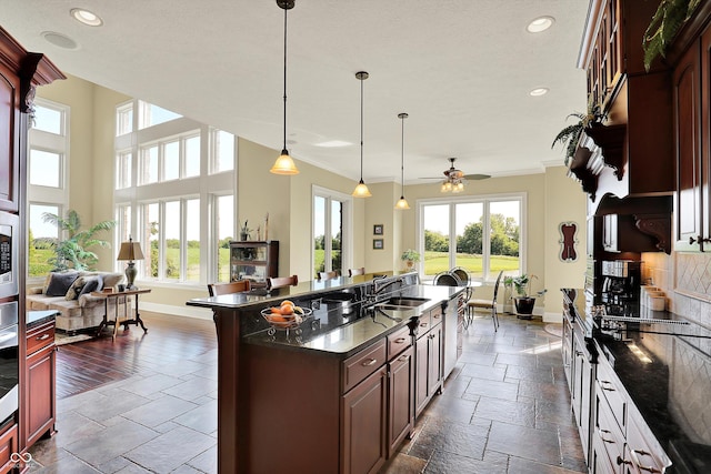 523 S 700 E, Whitestown, IN 46075 - kitchen featuring recessed lighting, a center island with sink, ceiling fan, open floor plan, and stone tile flooring