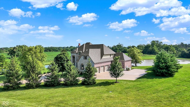 523 S 700 E, Whitestown, IN 46075 - view of side of property featuring a water view, driveway, a yard, a chimney, and stone siding