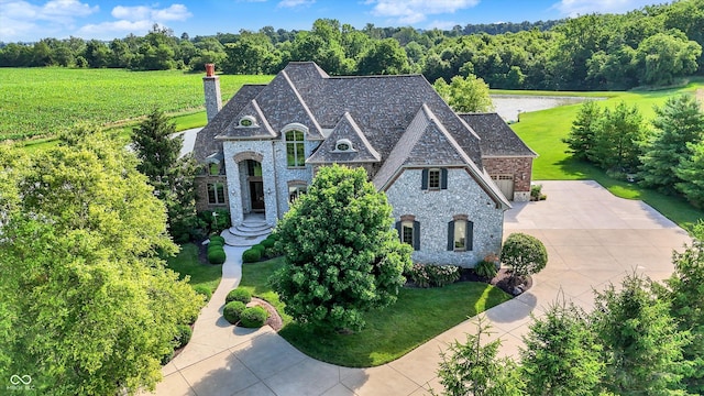 523 S 700 E, Whitestown, IN 46075 - view of front of home with a chimney, brick siding, concrete driveway, a front lawn, and stone siding