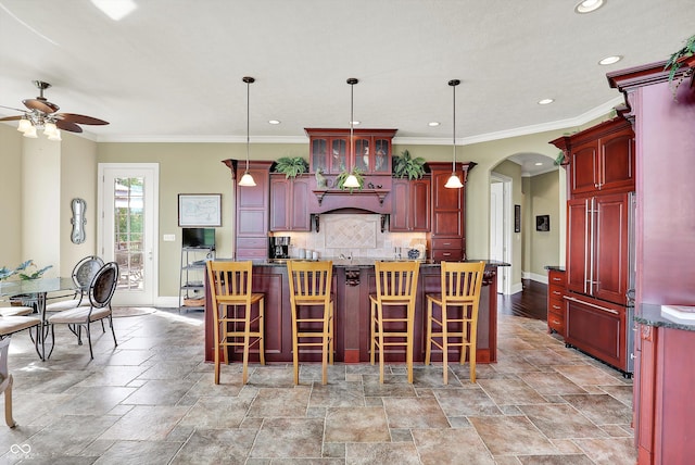 523 S 700 E, Whitestown, IN 46075 - kitchen with reddish brown cabinets, ceiling fan, arched walkways, paneled built in fridge, and recessed lighting