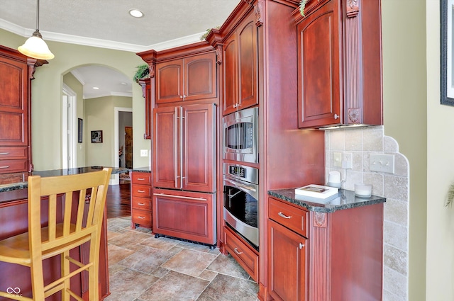 523 S 700 E, Whitestown, IN 46075 - kitchen with reddish brown cabinets, built in appliances, arched walkways, ornamental molding, and recessed lighting