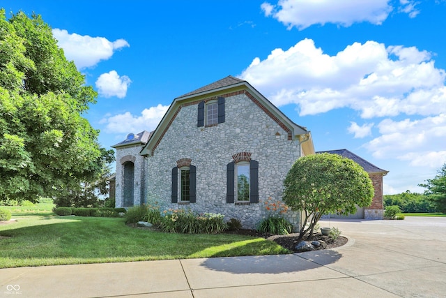 523 S 700 E, Whitestown, IN 46075 - view of home's exterior with stone siding, concrete driveway, and a lawn