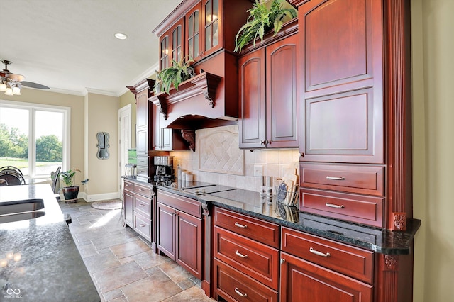 523 S 700 E, Whitestown, IN 46075 - kitchen featuring reddish brown cabinets, a ceiling fan, crown molding, light stone finish flooring, and black electric stovetop