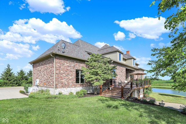 523 S 700 E, Whitestown, IN 46075 - view of front of house with brick siding, a front lawn, a deck with water view, and a chimney