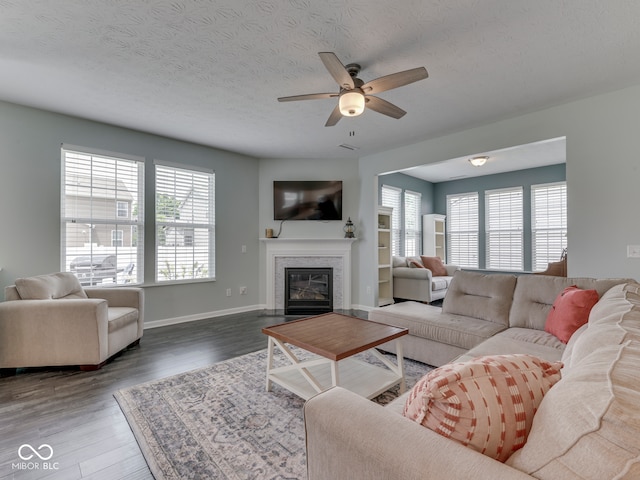 8330 Whitaker Valley Blvd, Indianapolis, IN 46237 - living room featuring a ceiling fan, plenty of natural light, wood finished floors, a fireplace with flush hearth, and a textured ceiling