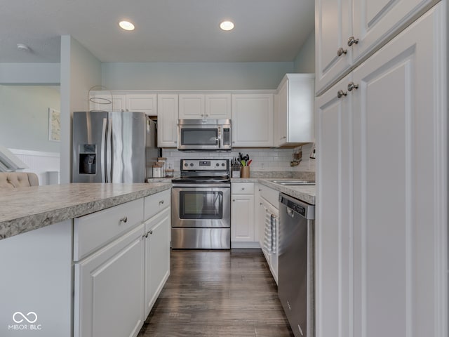 8330 Whitaker Valley Blvd, Indianapolis, IN 46237 - kitchen with stainless steel appliances, light countertops, white cabinetry, backsplash, and recessed lighting