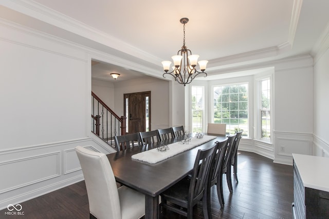 10334 Strongbow Rd, Fishers, IN 46040 - dining space featuring a decorative wall, a chandelier, ornamental molding, dark wood-type flooring, and stairs