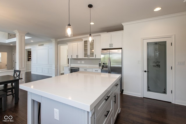 10334 Strongbow Rd, Fishers, IN 46040 - kitchen with ornate columns, wine cooler, glass insert cabinets, white cabinets, and pendant lighting