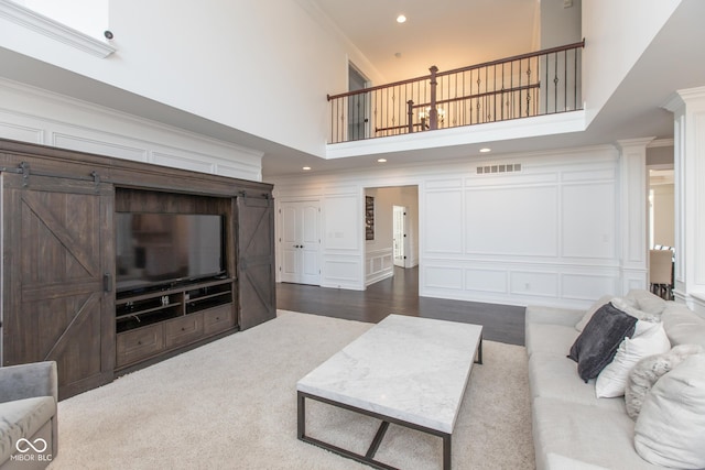 10334 Strongbow Rd, Fishers, IN 46040 - living area with a decorative wall, ornamental molding, a high ceiling, recessed lighting, and ornate columns