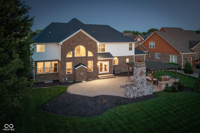 10334 Strongbow Rd, Fishers, IN 46040 - rear view of property featuring french doors, a patio area, a lawn, and brick siding