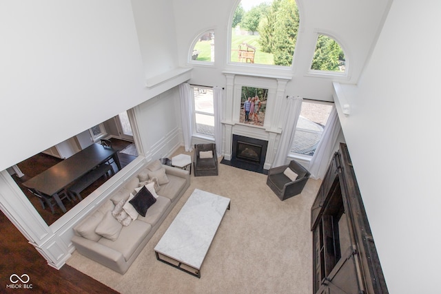 10334 Strongbow Rd, Fishers, IN 46040 - carpeted living area with a fireplace with flush hearth, healthy amount of natural light, and a towering ceiling