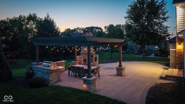 10334 Strongbow Rd, Fishers, IN 46040 - fenced backyard featuring an outdoor fireplace and a patio area