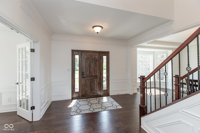 10334 Strongbow Rd, Fishers, IN 46040 - foyer entrance with a decorative wall, wood finished floors, stairway, a wainscoted wall, and ornamental molding